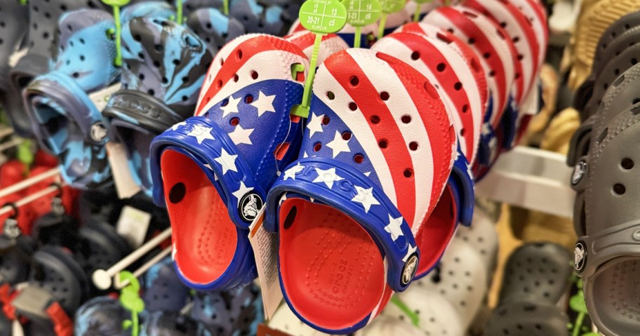 american flag print crocs clogs on store display rack