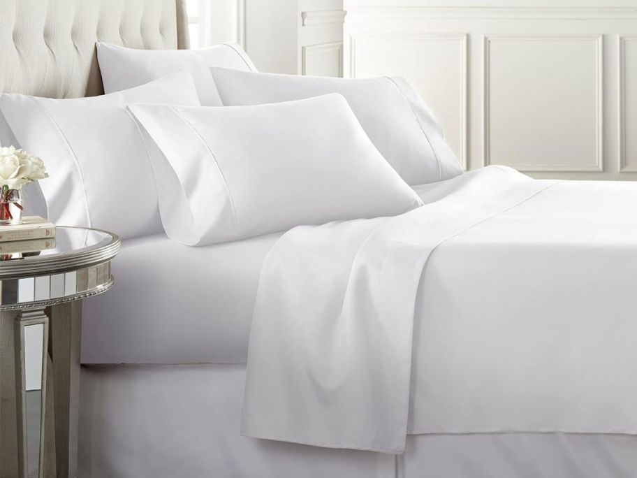 A bed with white Danjor linen sheets on it