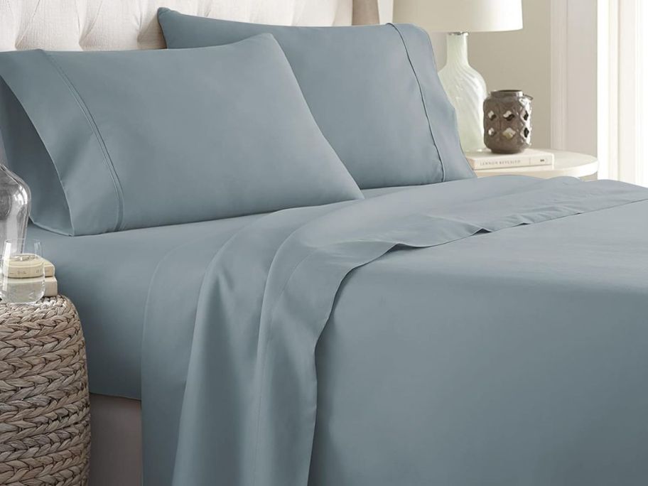 A bed with spa blue Danjor linens sheets on it
