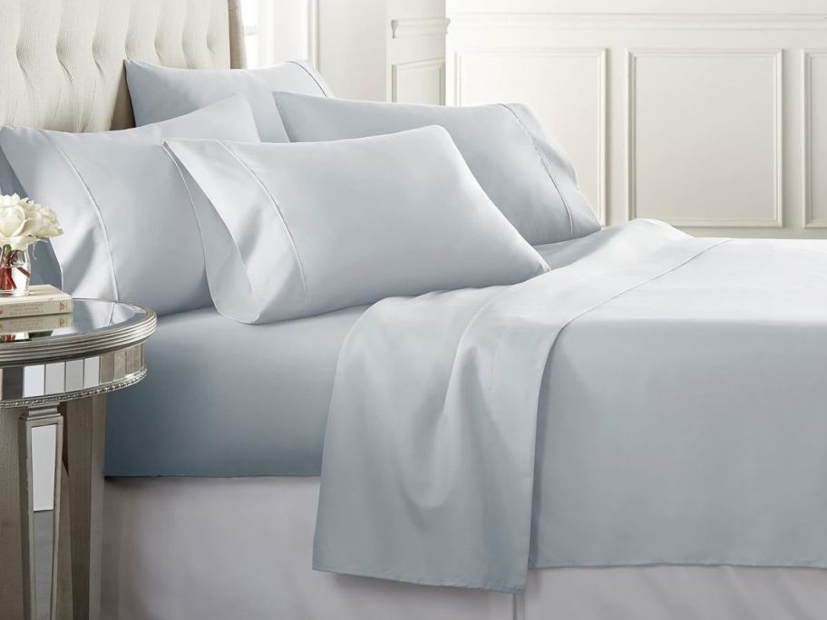 A bed with Ice Blue Danjor Linens sheets on it