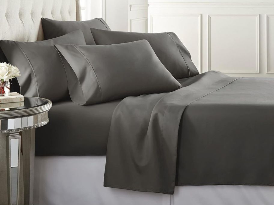 A bed with Gray Danjor Linens sheets on it