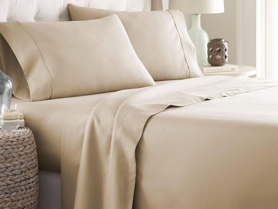A tan set of Danjor Linen Sheets on a bed