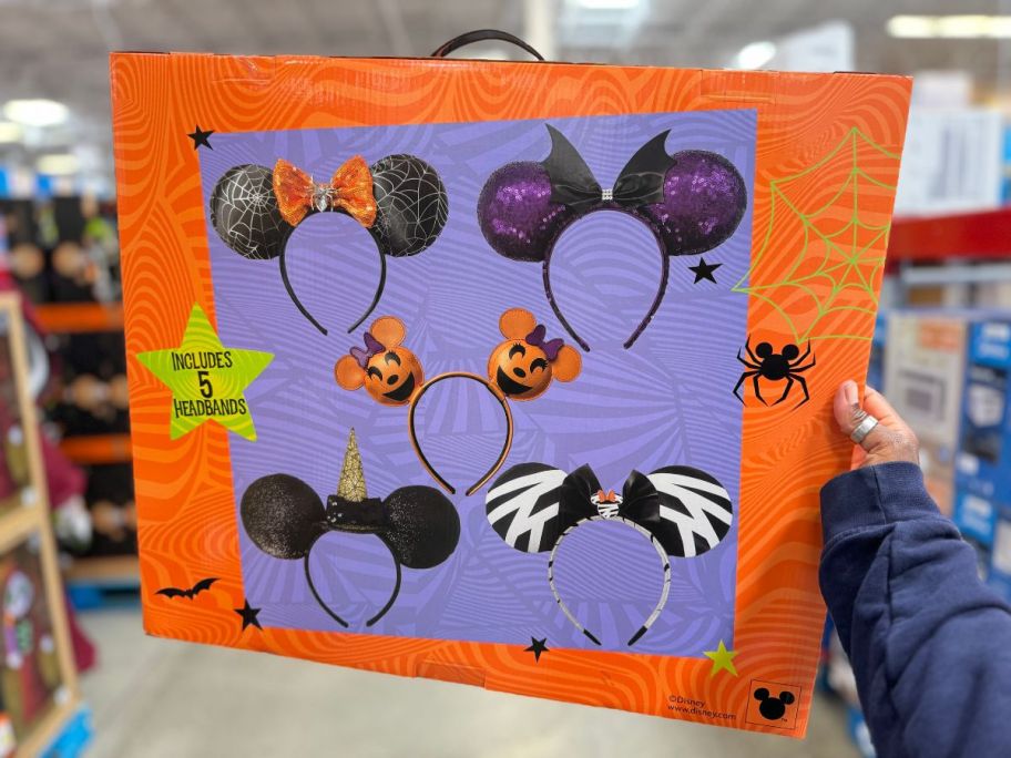 the back of the Disney Halloween 5-Piece Ears Deluxe Headband Set box being held by hand in store