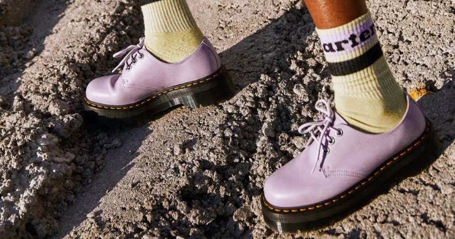 person wearing purple platform shoes and yellow crew socks