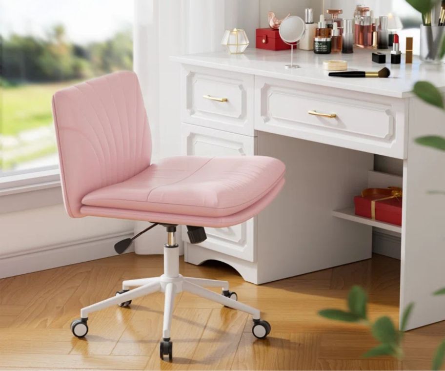 a pink rolling task chair