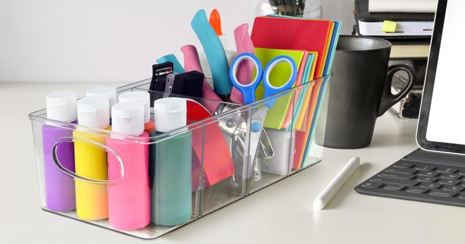 clear organizing bin with removable dividers filled with craft supplies