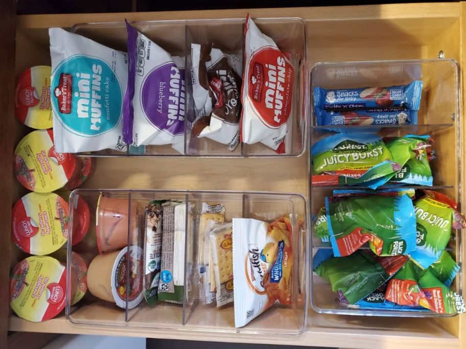 kitchen drawer with clear organizing divided bins filled with snacks