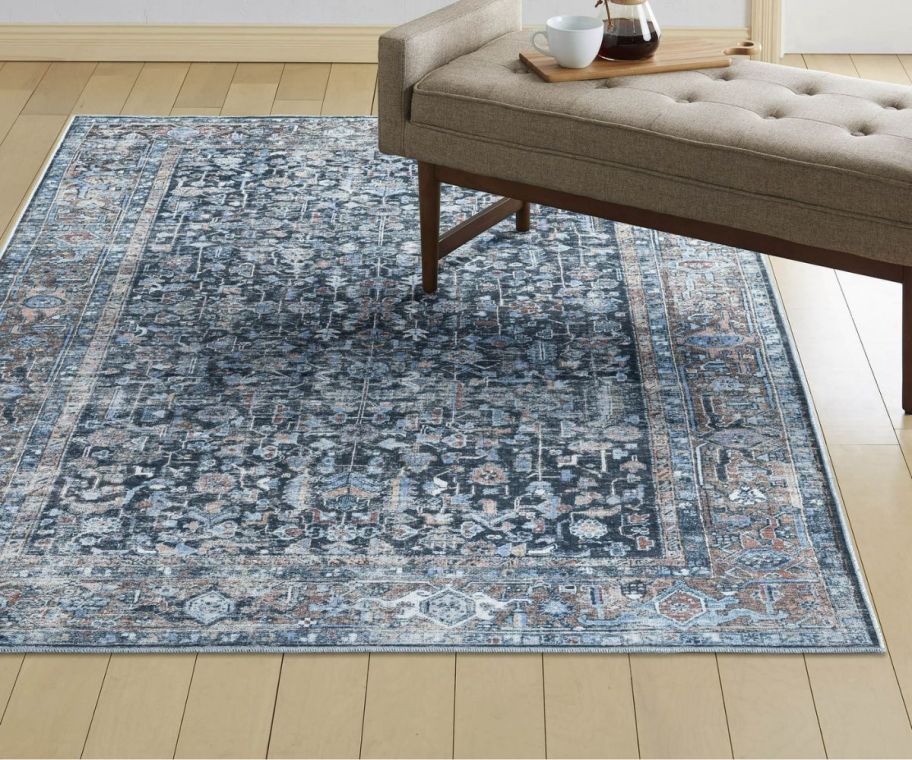 a blue distressed vintage rug on a hardwood floor