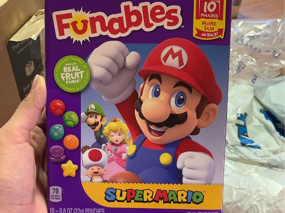 Hand holding up a box of Funables Super Mario Fruit Snacks
