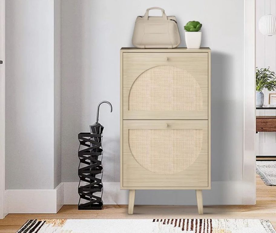 a natural colored rattan shoe cabinet
