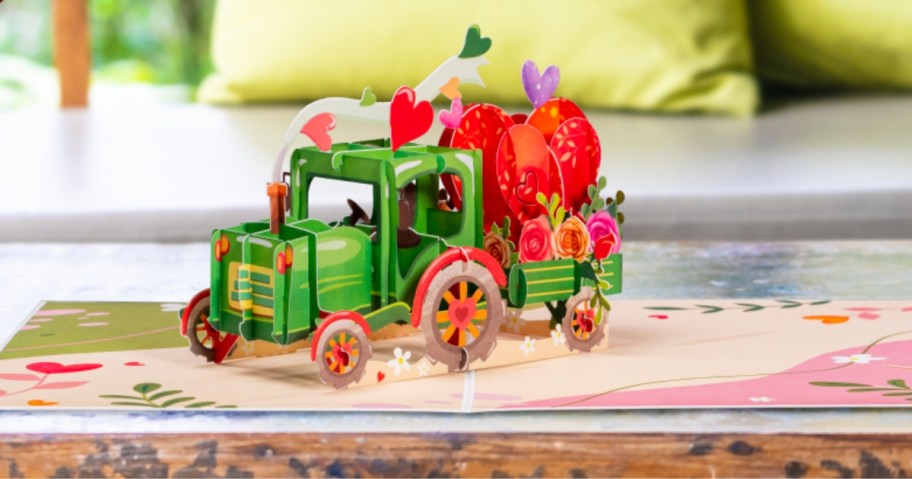 3D pop up card on a table with tractor and fruit and veggies