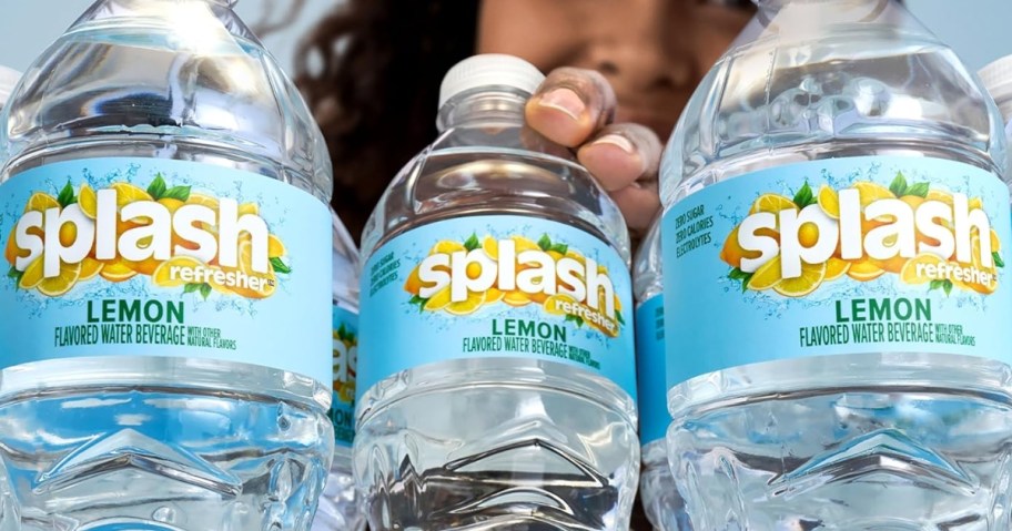 person reaching for a bottle of Splash Refresher Lemon Flavored Water with 2 more bottles beside it