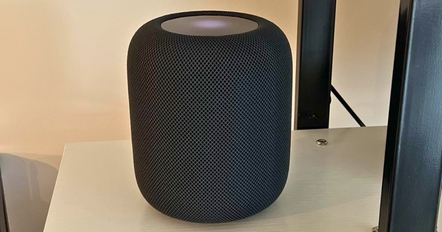 black Apple HomePod speaker on a shelf