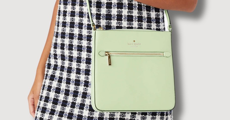 woman wearing black and white gingham dress with a light green Kate Spade crossbody purse