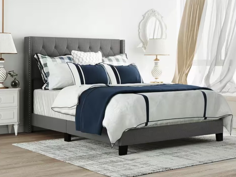 grey upholstered platform bed in a bedroom