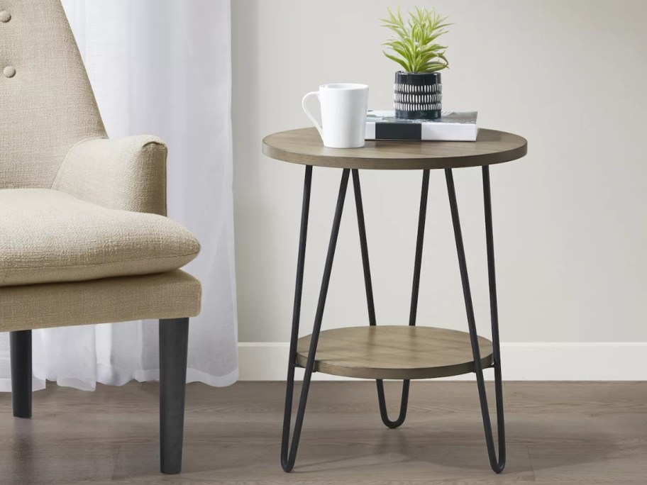 modern wood and metal side table by an accent chair