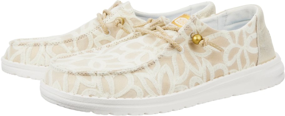 pair of white and gold flower print sneakers