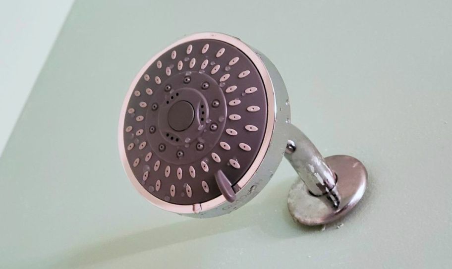 a 4 inch chrome shower head installed in a shower 