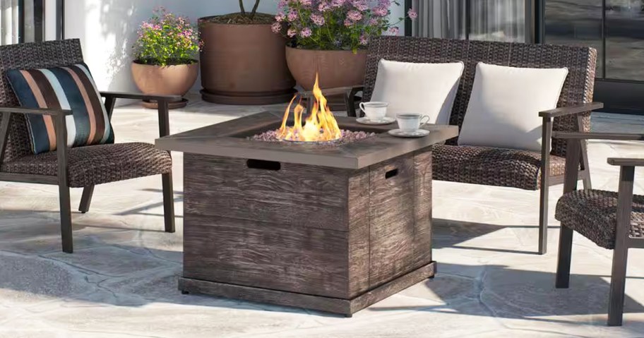square fire pit in middle of patio set