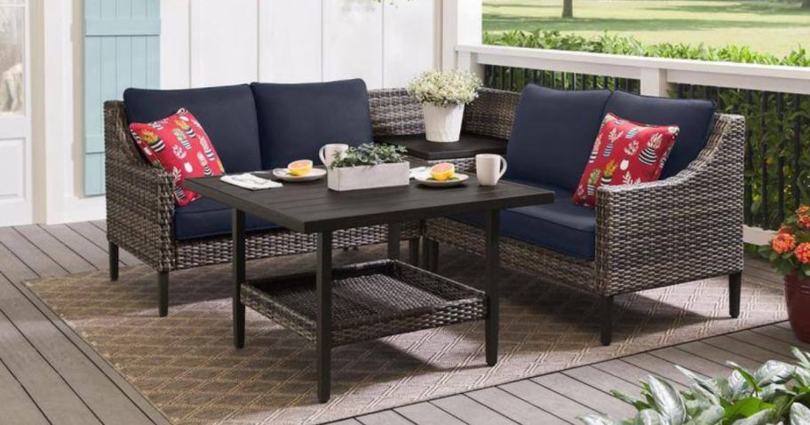 A navy blue patio set with a love seat, chairs, and a table outside