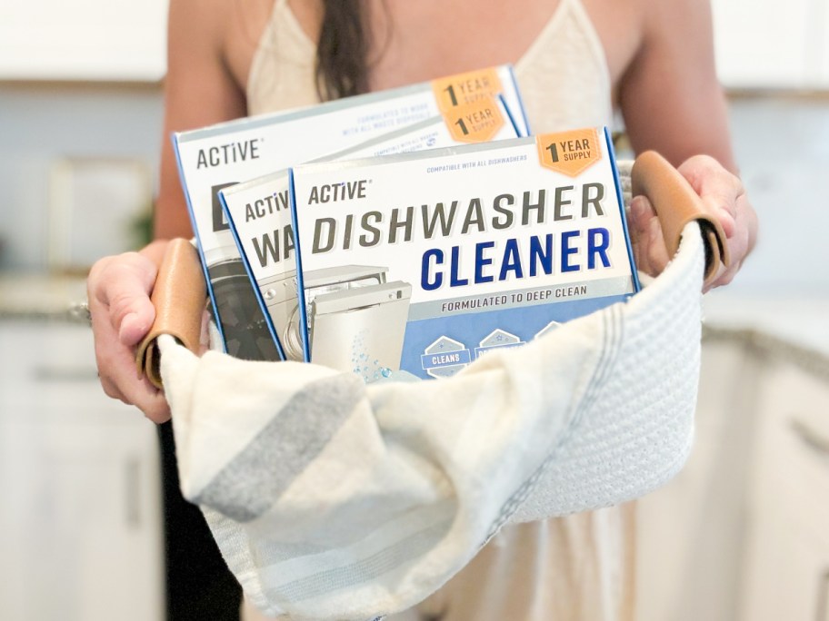Hand holding basket filled with active cleaners