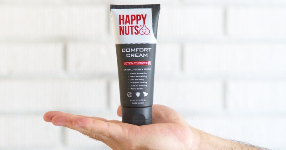 hand holding a tube of Happy Nuts Comfort Cream