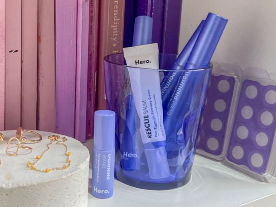 A cup on a shelf filled with Hero Cosmetics Skin Care