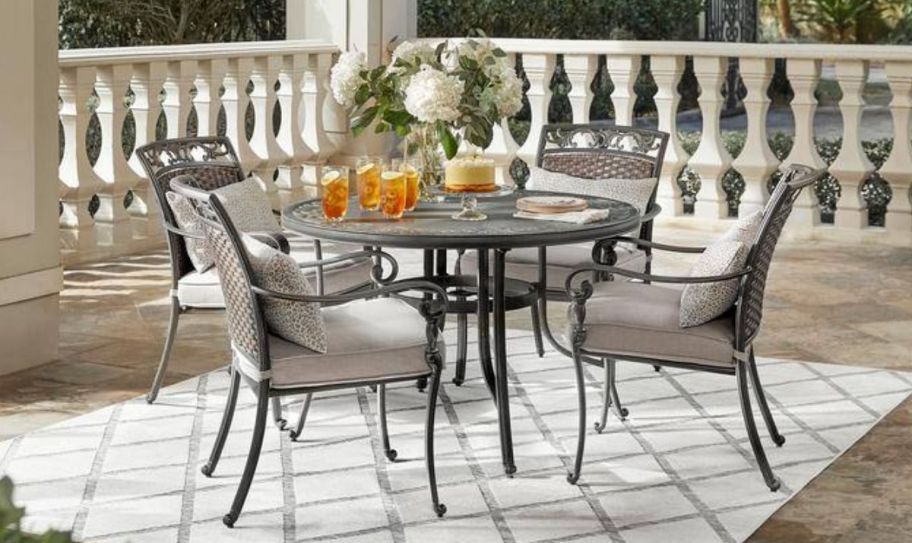 a 5 piece outdoor dining set on a front porch