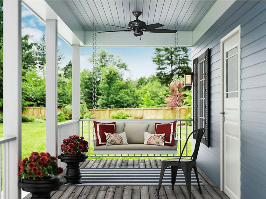 Hunter Newsome 52" Indoor/Outdoor Ceiling Fan set up on a porch with a porch swing