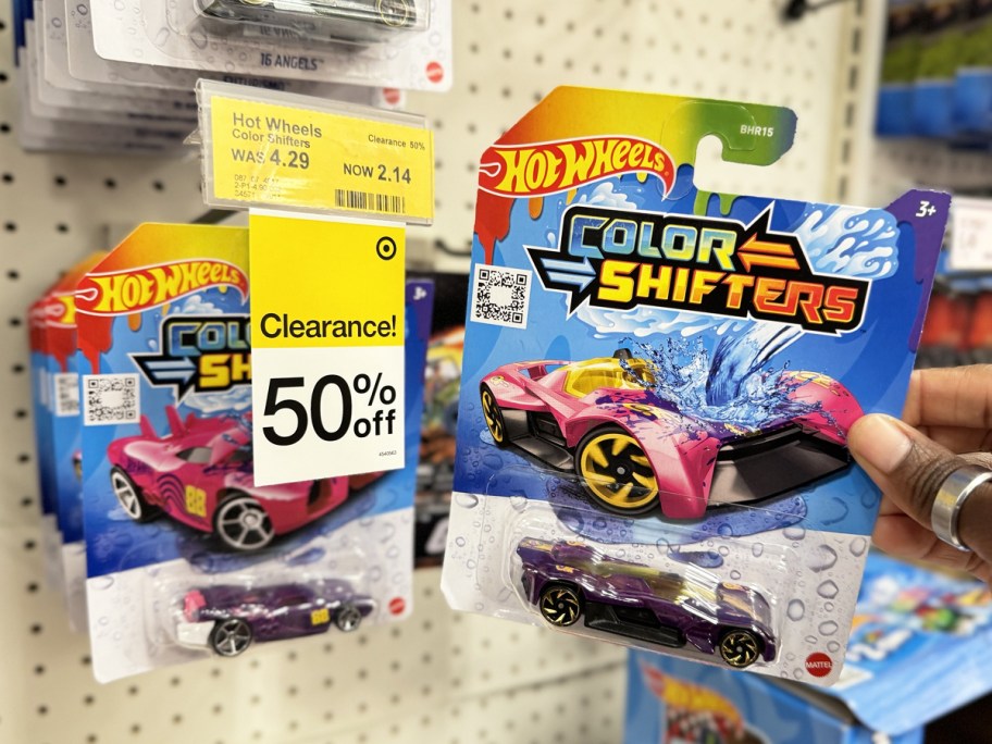 hand holding Hot Wheels Color Shifters car next to 50% off clearance tag