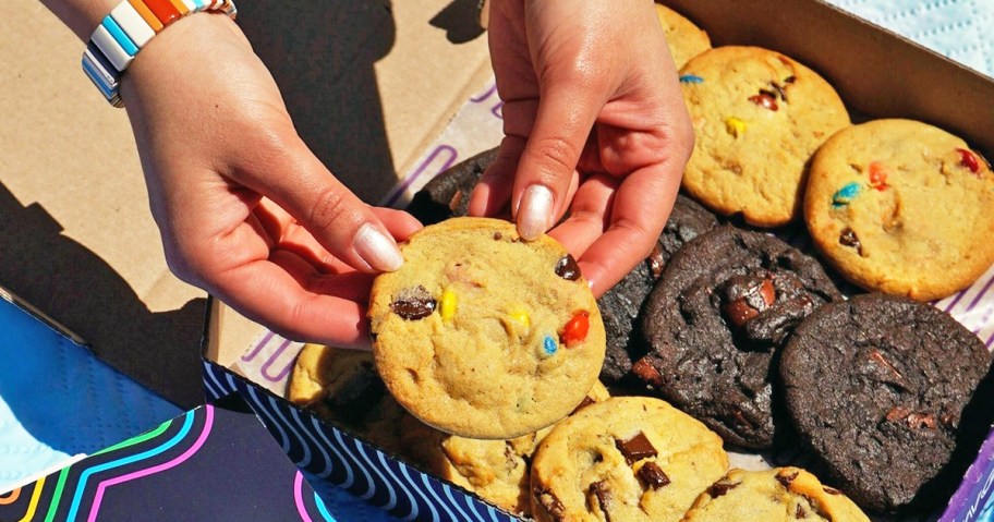 hands holding an m&ms cookie