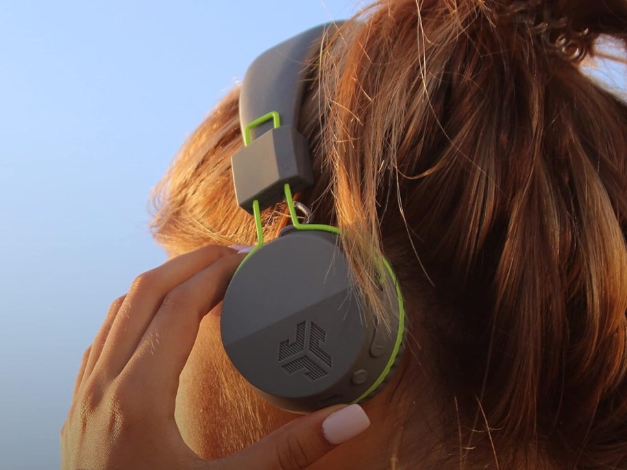 woman wearing grey headphones