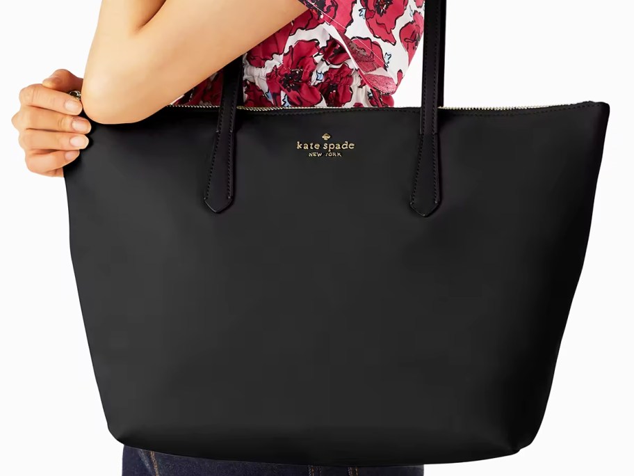 woman with a large black kate spade tote bag