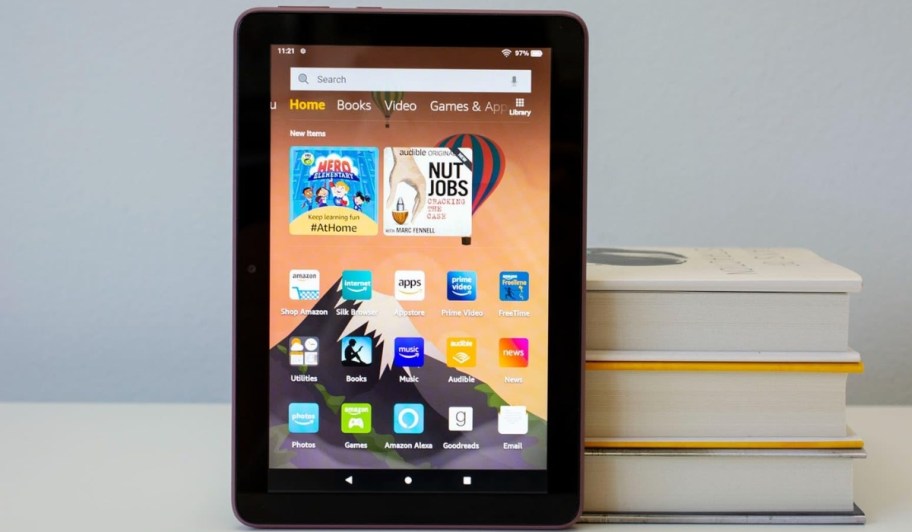 Amazon Fire HD 8 Plus 64 GB Tablet w/ 8" Display next to books