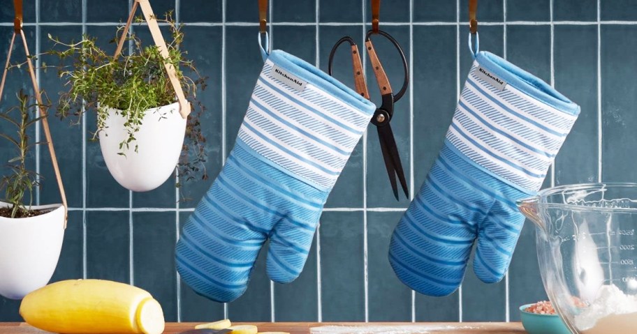 set of blue and white oven mitts hanging in kitchen