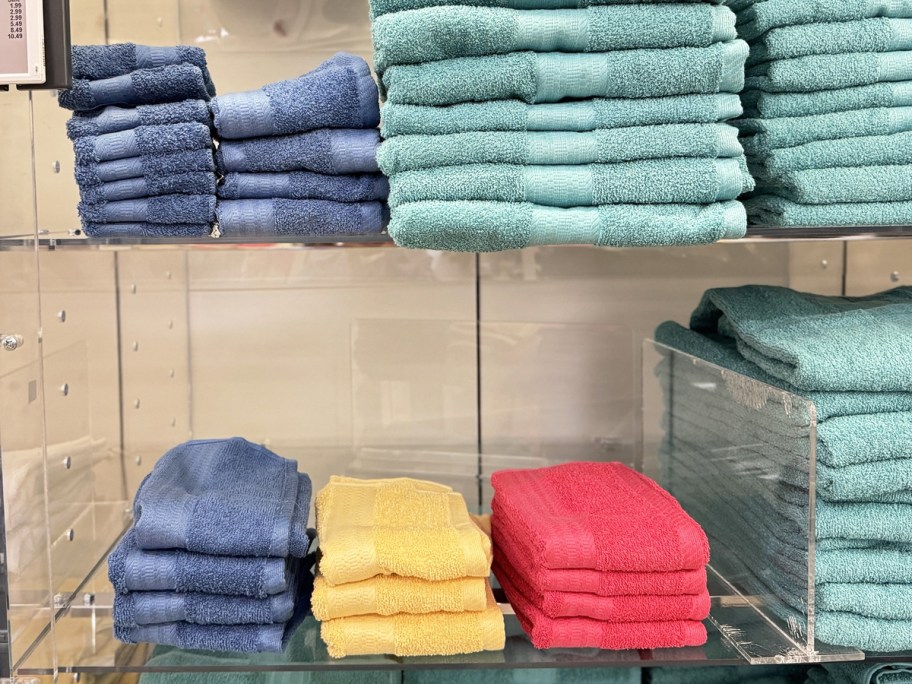 washcloths, hand towels, and bath towels on display racks in store