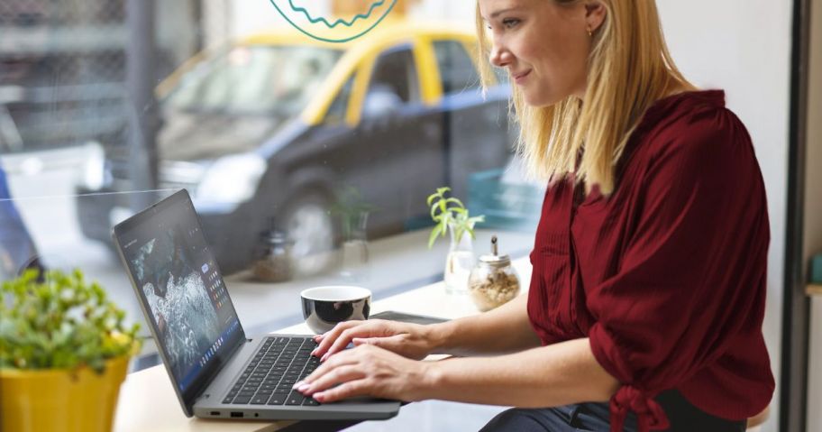 woman using a Lenovo Ideapad at a coffee shop