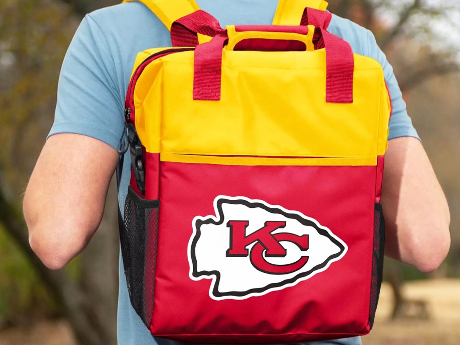man wearing red and yellow Kansas City Chiefs backpack cooler