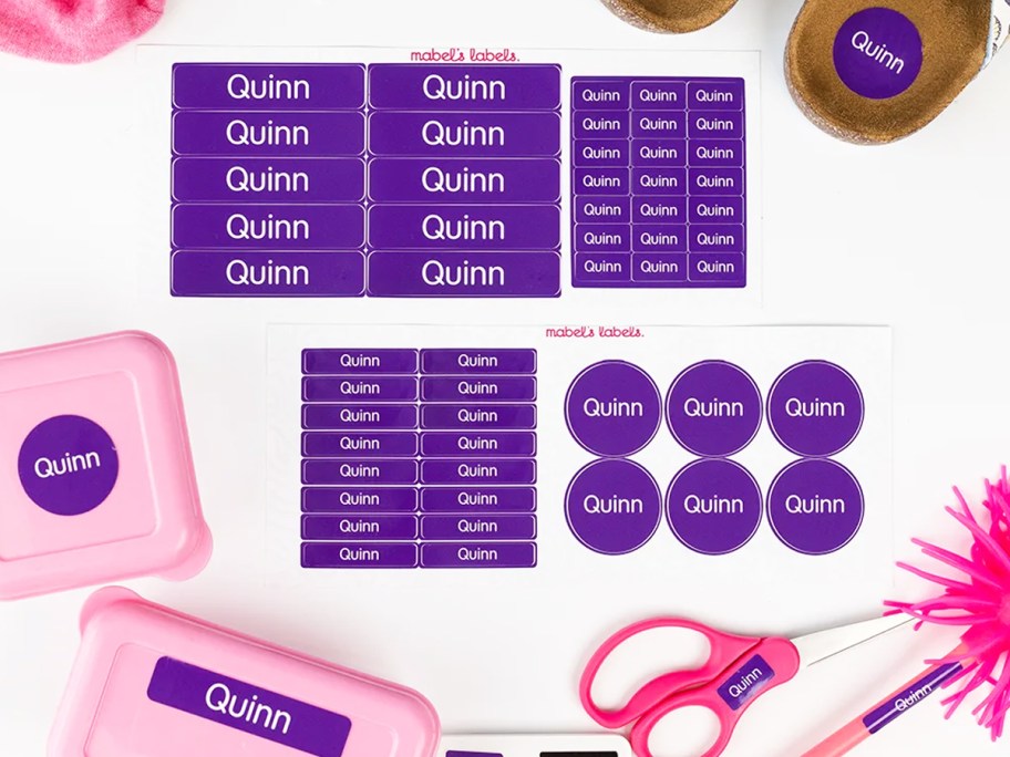 purple sets of name labels surrounded by school supplies