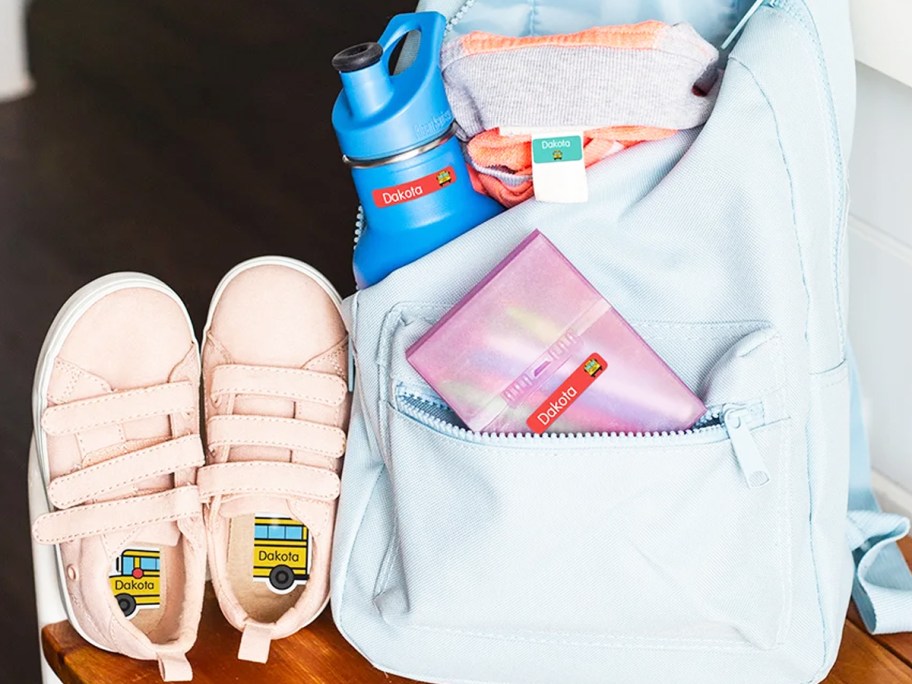 shoes, backpack, water bottle, and clothing with name labels