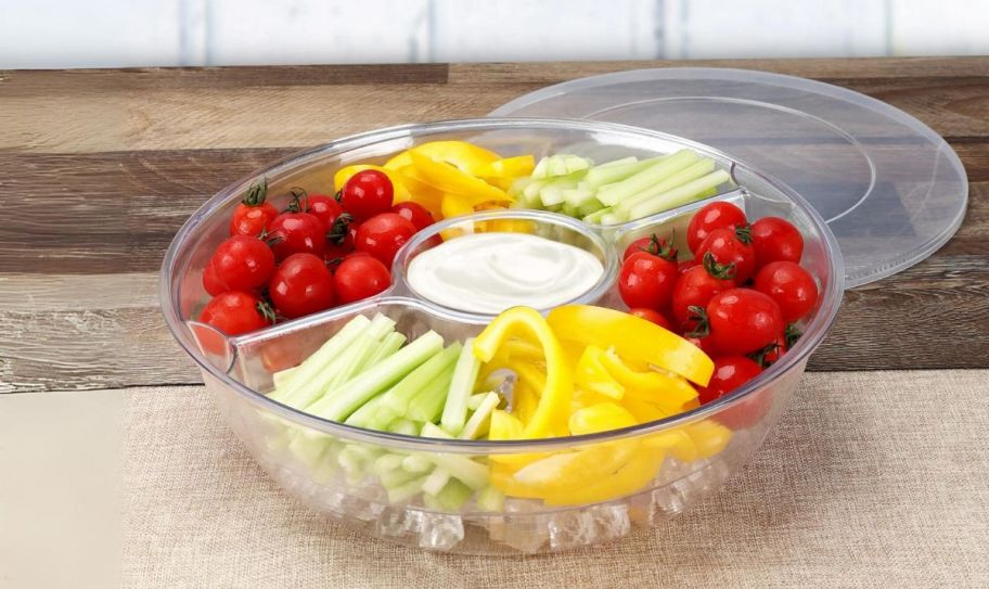 a clear acrylic appetizer on ice serving tray on a kitchen counter