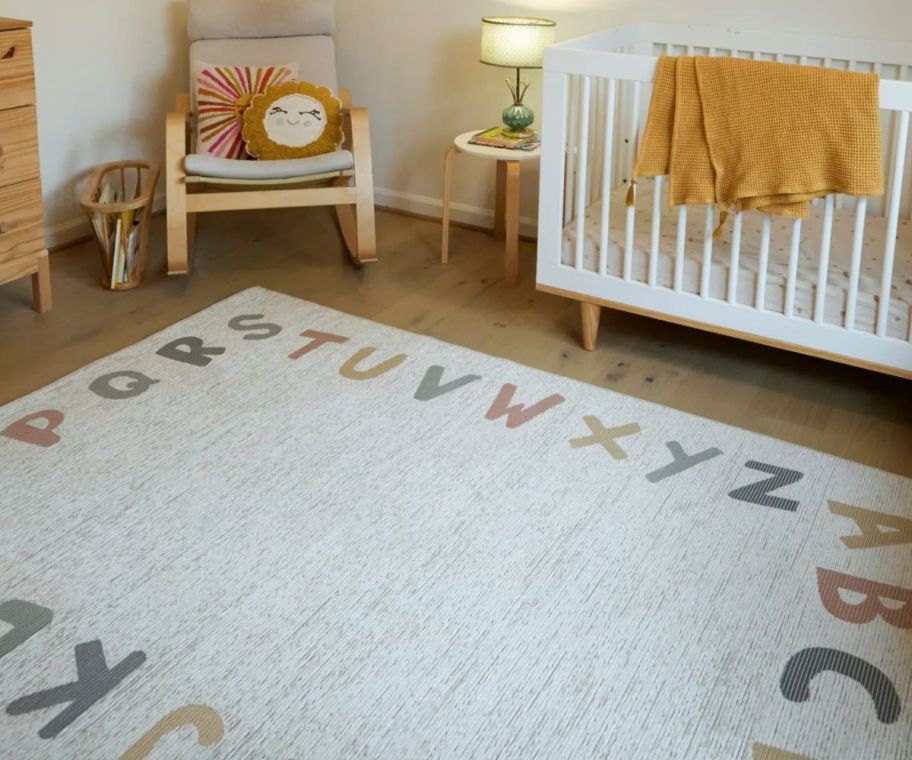 a neutral colored area rug in a nursery