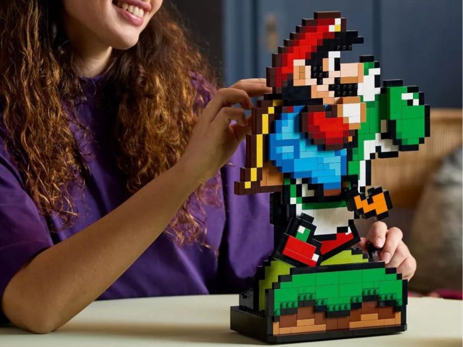woman touching a Super Mario World: Mario & Yoshi LEGO set