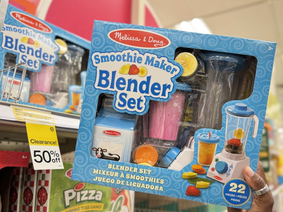 hand holding up Melissa & Doug 22-Piece Smoothie Maker Blender Set toy in store