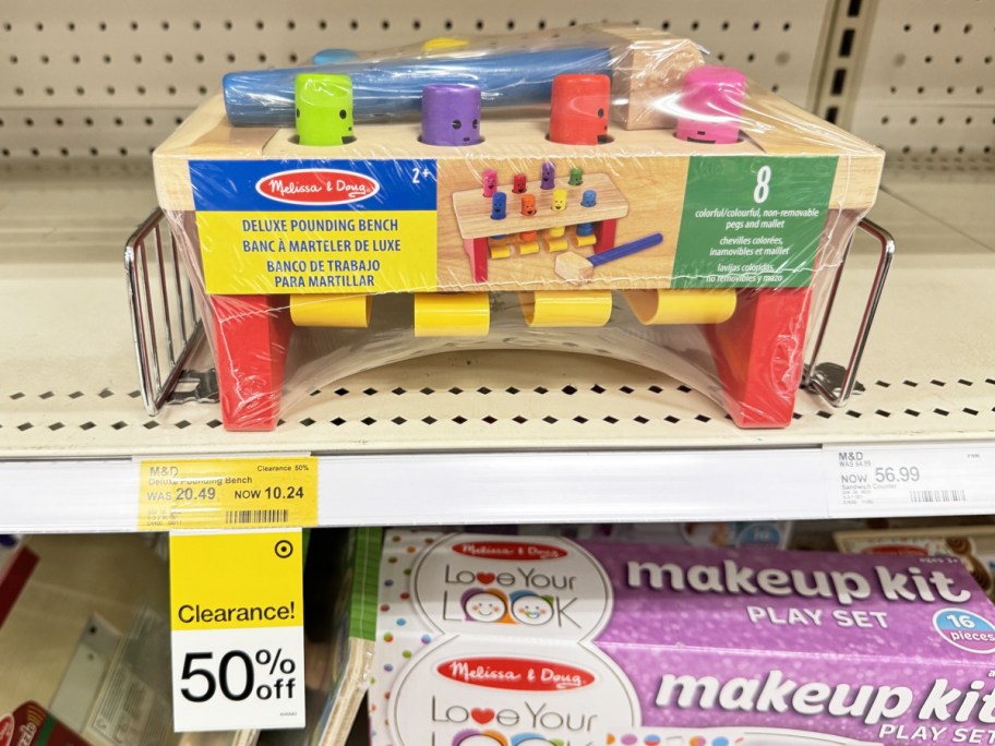 Melissa & Doug Deluxe Pounding Bench on shelf with 50% off clearance tag