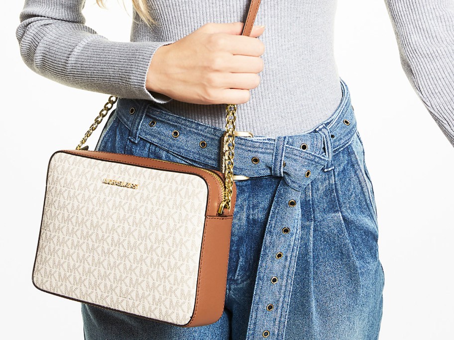 woman with a white and brown crossbody bag