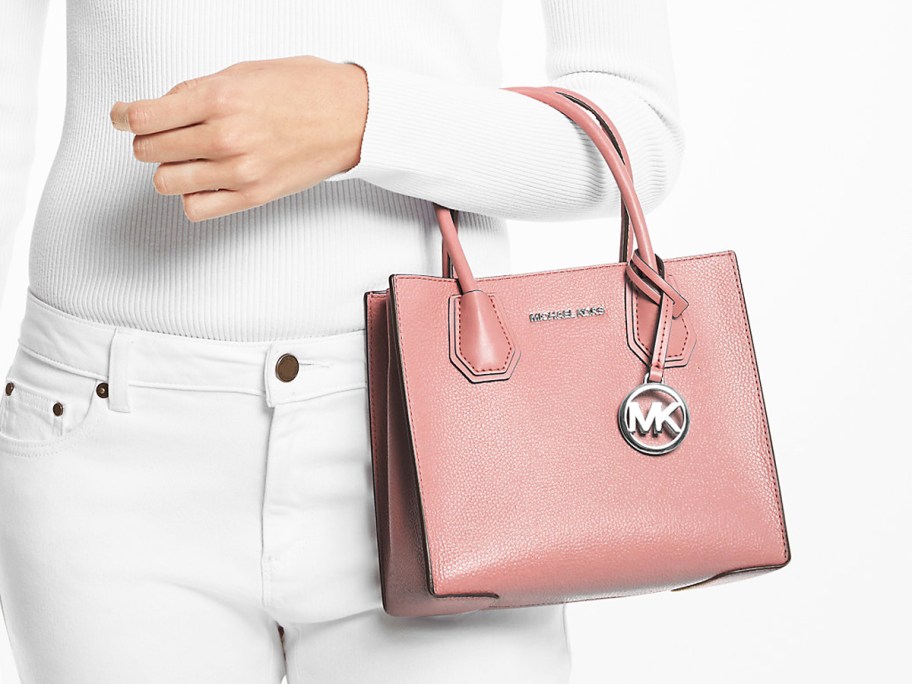 woman in a white outfit with a pink purse