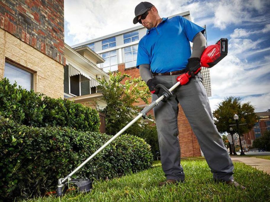 Man using a Milwaukee String Trimmer