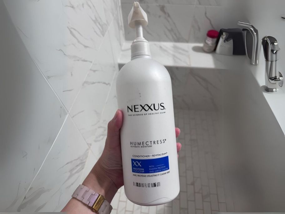 Nexxus Humectress Ultimate Moisture Conditioner 33.8oz in hand in shower