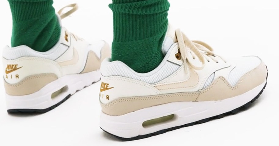 wearing a pair of nike air max shoes with green crew socks